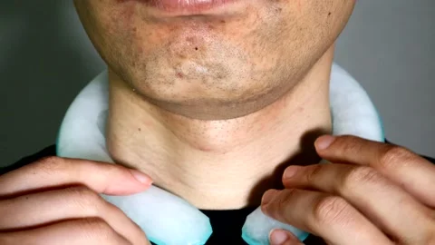 A person with an ice pack around their neck Stock Footage 334632661