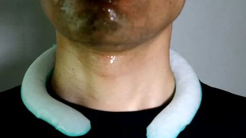 A person with an ice pack around their neck Stock Footage 334636880
