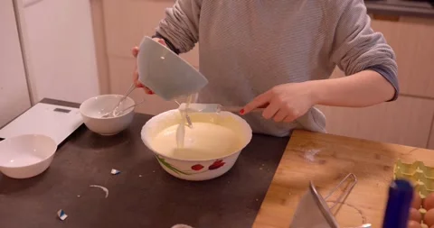 A person is immersed in the culinary art of baking Stock Footage 331400620