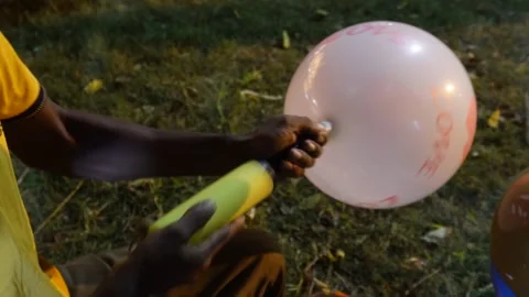 Person Inflating Balloon 스톡 동영상 328511511