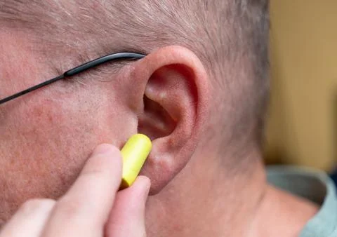 Person Inserting Earplugs into Ear Close-Up Hearing 스톡 사진