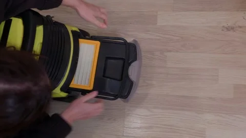 Person inserting HEPA filter into vacuum cleaner maintenance Stock Footage 336746287