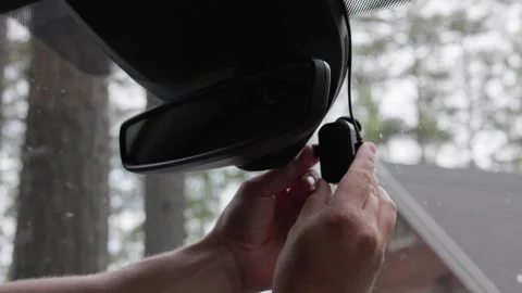 A person inserting a memory card into a dash camera. horizontal slow-motion. Stock Footage 341361347