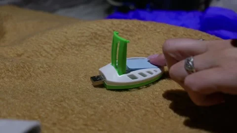Person Inserting Mosquito Repellent Mat Into Portable Usb Vaporizer Stock Footage 345170824