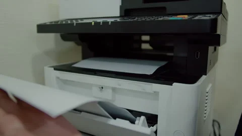 Person inserting paper into multifunction printer tray Stock Footage 311183826