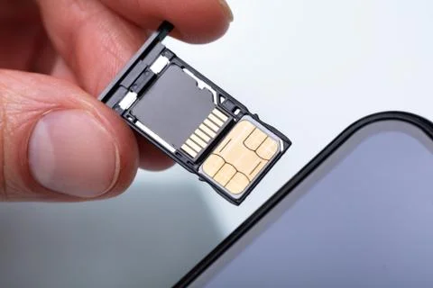 Person Inserting Sim Card In Cellphone Stock Photos