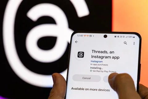 Person installing the new app Threads by Instagram from Google Play Store Stock Photos