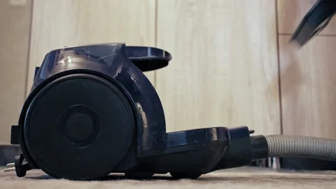 A person installs a new dust filter and reusable dust bag into a vacuum cleaner Stock Footage 130541908
