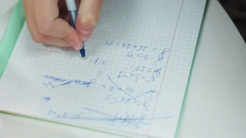 Person intensely prepares for exam with notes and eraser fragments. Dedicated Stock Footage 328147305