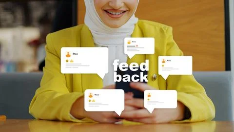 Person interacting with feedback comments in a cafe while wearing a yellow Stock Photos