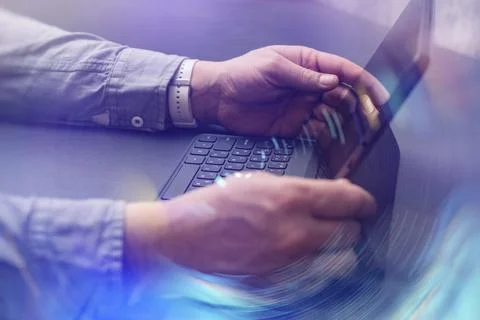 Person interacting with a tablet device with abstract network effects, symb.. Stock Photos
