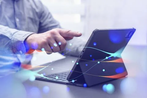 Person interacting with a tablet device with abstract network effects, symb.. Foto stock