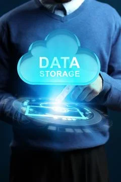 Person interacts with digital cloud symbol for data storage at an office setting Stock Photos