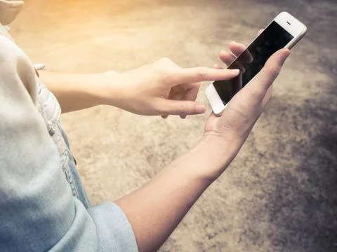 Person in jean jacket using mobile phone Stock Photos