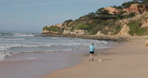 A person jogging along a beach Stock Footage 302897487