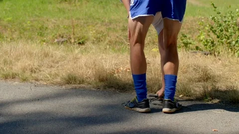 A person is jumping rope outdoors while wearing a blue athletic outfit Stock-Footage 318926970