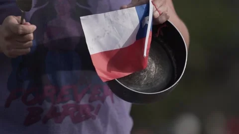 Person knocks saucepan in with protesters Stock Footage 136341435