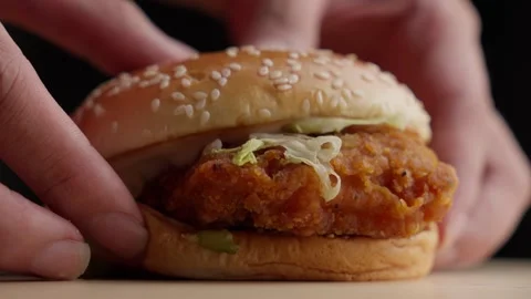 Person Lay Down A Crunchy Fried Chicken Burger On The Table. Rack Focus Stock Footage 275897465