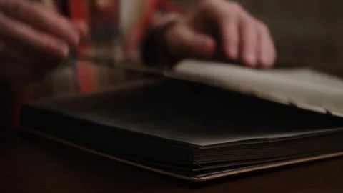 Person leafing through postage stamp collection album. closeup. Stock Footage 320210576