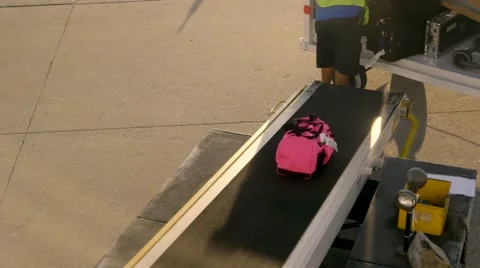 Person loading baggage onto plane, 4K Stock Footage 56221531