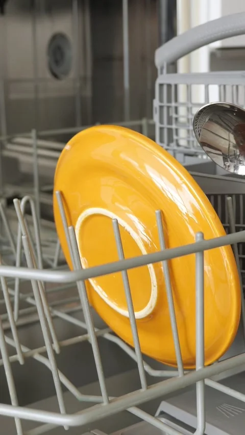 Person loading dirty plates into the dishwasher for cleaning Stock-Footage 341446564