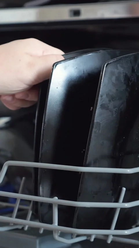 Person Loads Dark Ceramic Plates Into Dishwasher Rack Inside Modern Kitchen Stock Footage 346764181