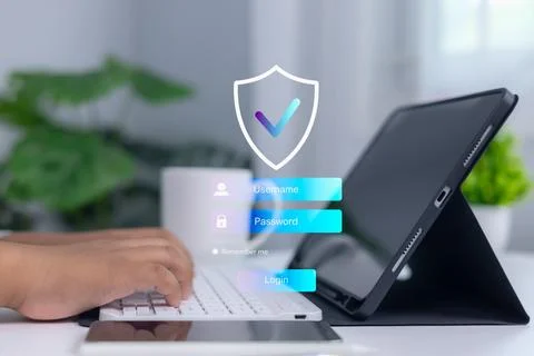 Person logging into secure system on digital tablet with shield and checkma.. Stock Photos