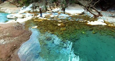 A Person is Looking to the Beautiful River View on the Rock, 4k Drone Shot Stock Footage 148421385