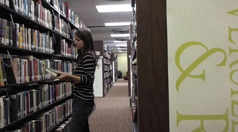 Person looking for a book at the library Stock Footage 46947779