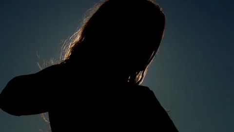 Person looking down backlit by glowing sun Stock Footage 336617172