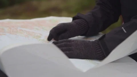 Person looking down at compass and map Stock Footage 81539964