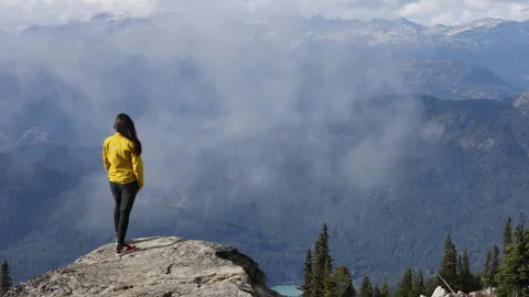 Person looking at mountain view. Hiker walking on summit of Blackcomb mountain Stock Footage 279514934