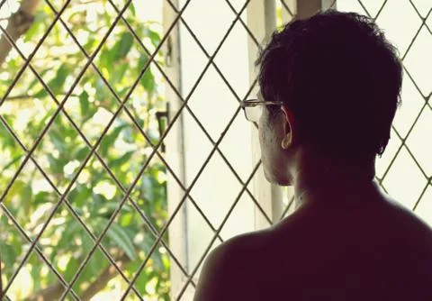 A person looking outside the window.Human behavior concept. Stock Photos