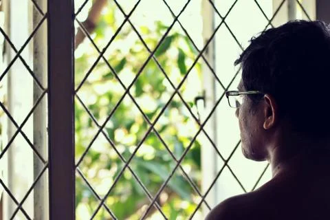 A person looking outside the window.Human behavior concept. Stock Photos