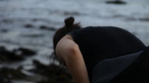 A person looking for shells at the shore Stock Footage 83165209