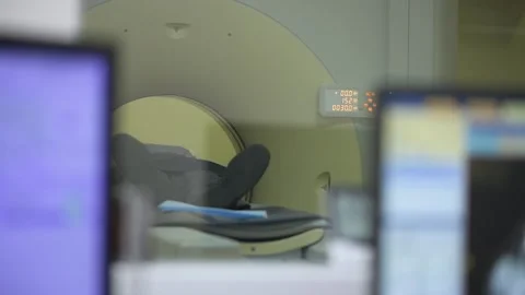 Person lying in CT-scanner to undergo tomography in hospital Stock Footage 195446943