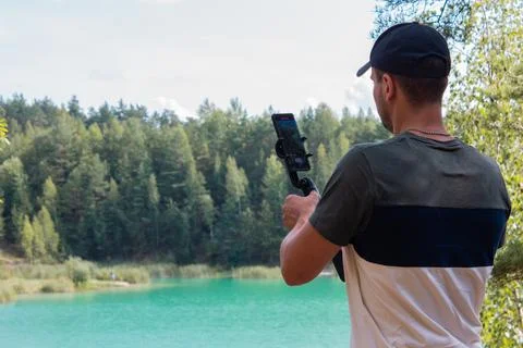 A person makes content in a pine forest Stock Photos