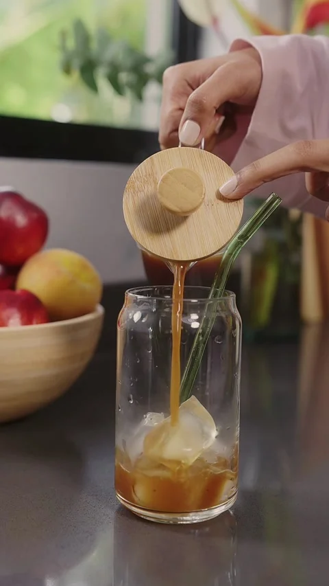 Person makes iced coffee by adding ice and milk Stock Footage 331773844