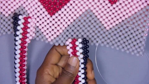 Person making beaded bag. Fixing hand of a bag Stock Footage 204114752