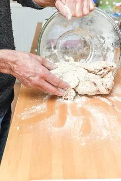 Person making bread in home kitchen adding ingredients to make the dough Stock Photos