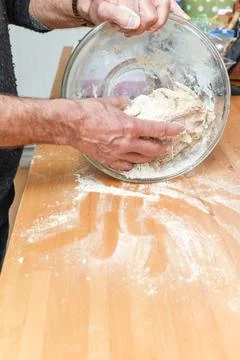 Person making bread in home kitchen adding ingredients to make the dough Stock Photos
