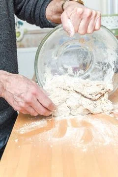 Person making bread in home kitchen adding ingredients to make the dough Stock Photos