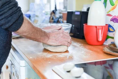 Person making bread in a home kitchen adding ingredients to make the dough an Foto stock