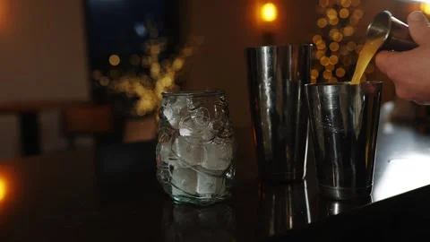 A person is making a drink with ice cubes in a glass Stock Footage 295996205