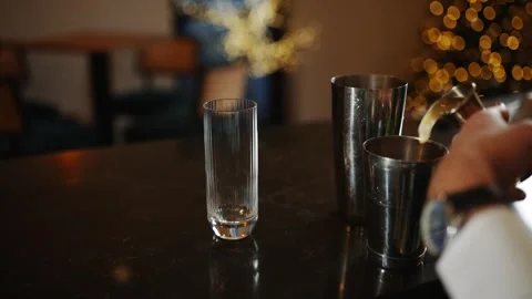 A person is making a drink with a spoon in a silver cup Video stock 295996154