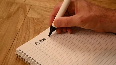 A person making a handwritten plan for 2023 Stock Footage 221793034