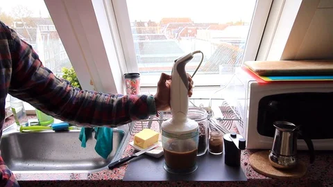Person making nutritious coffee with grass butter at home - 25 sec Stock Footage 128777700