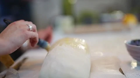 A person is making a pastry with a brush Stock Footage 295370368