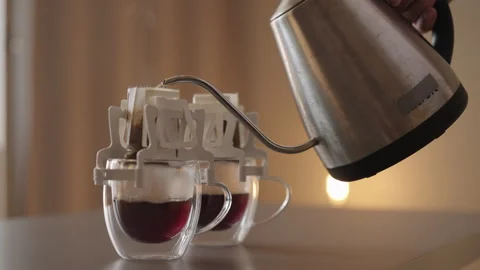 Person making quick and easy cup of black coffee using disposable drip bag Stock Footage 321603307