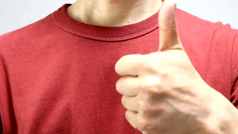 A person making a thumbs-up gesture 動画素材 335600101